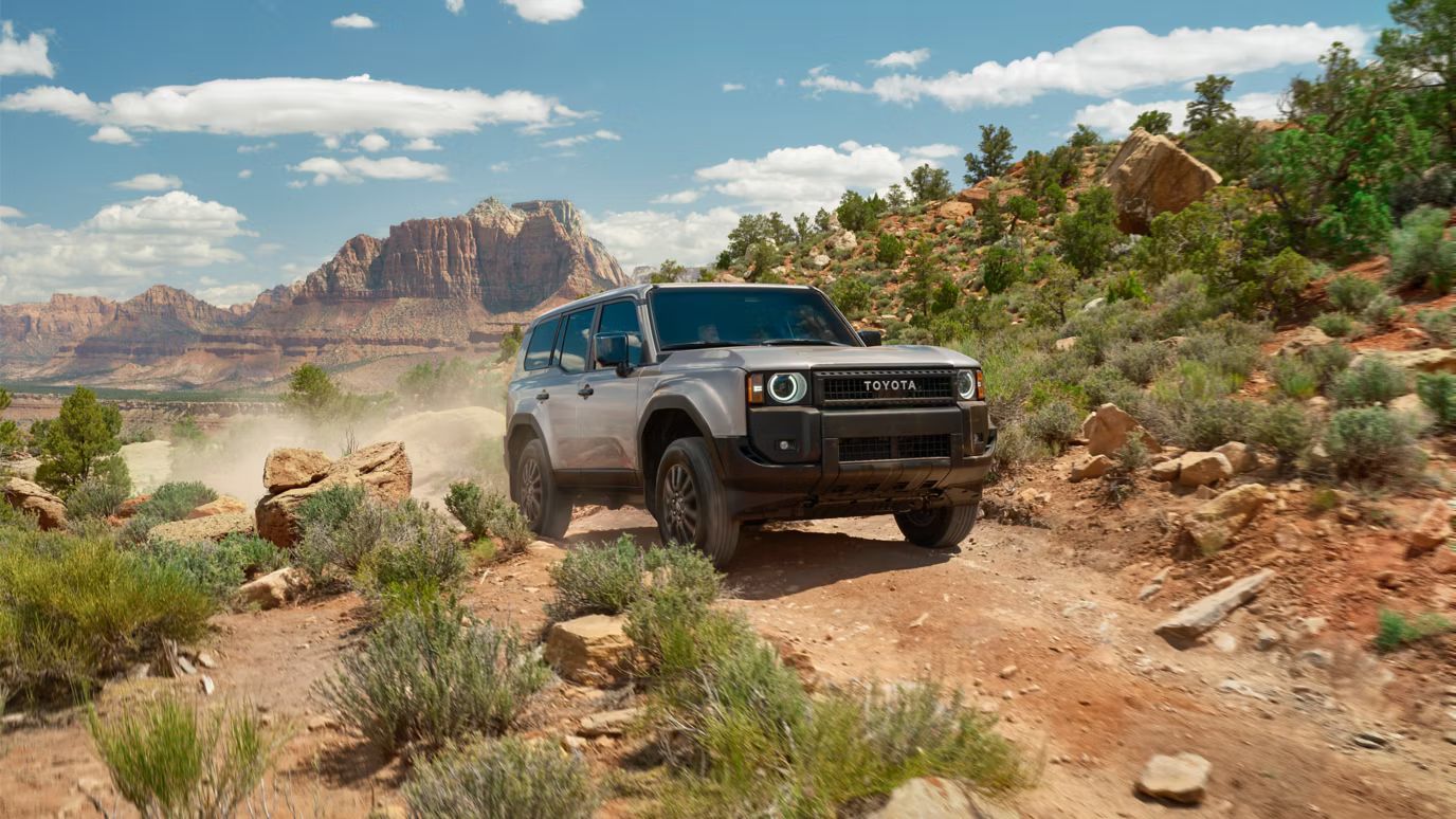 2026 Toyota Land Cruiser driving on a rocky off-road trail